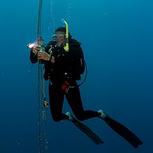 Diver descending on guide line with Sola light attached to wrist